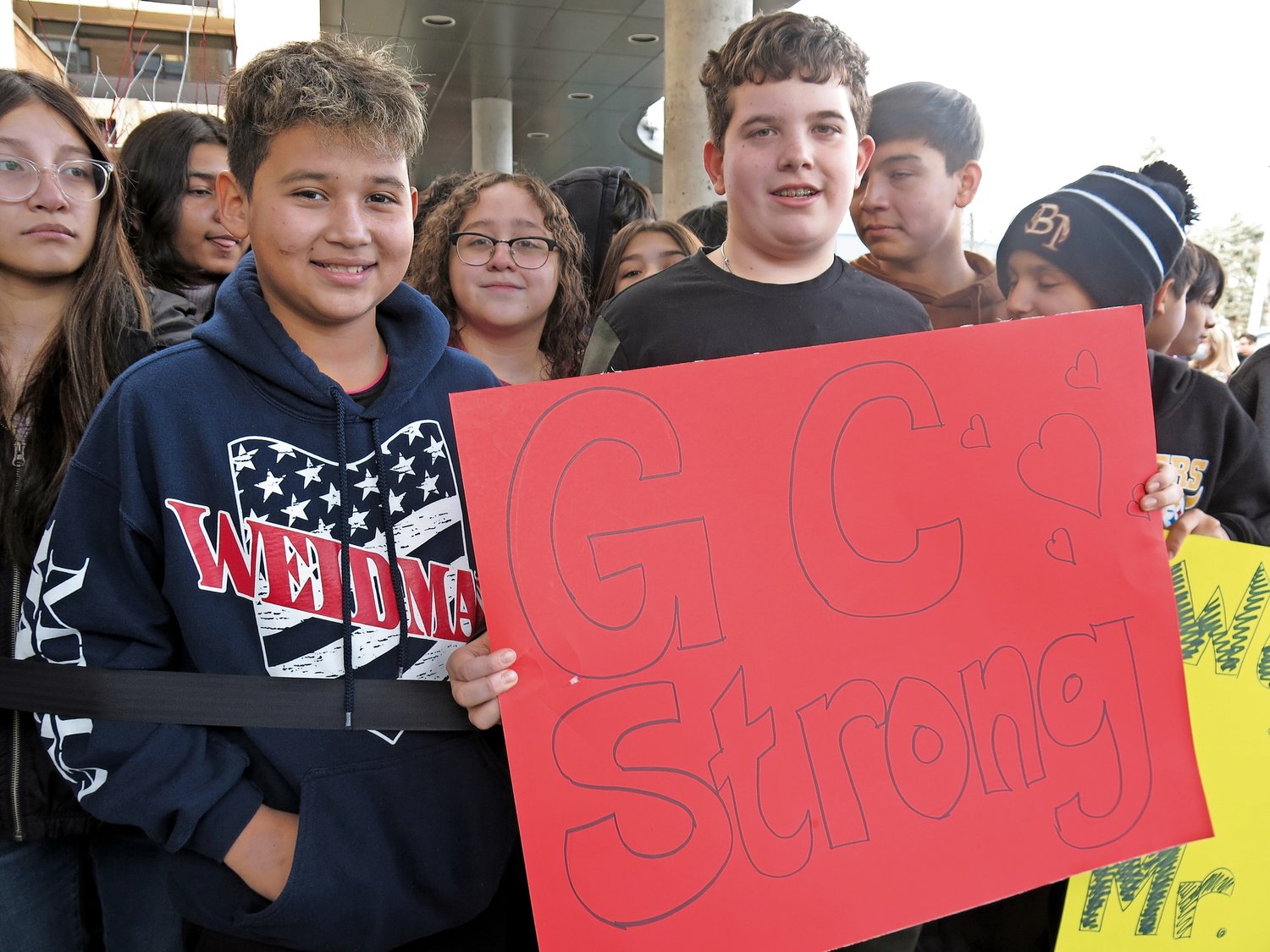 Jefferson Thomas, 13, and Thanasi Averopoulos, 12, from Finley Middle School, made a sign of encouragement for Carlos Vazquez, their favorite crossing guard.